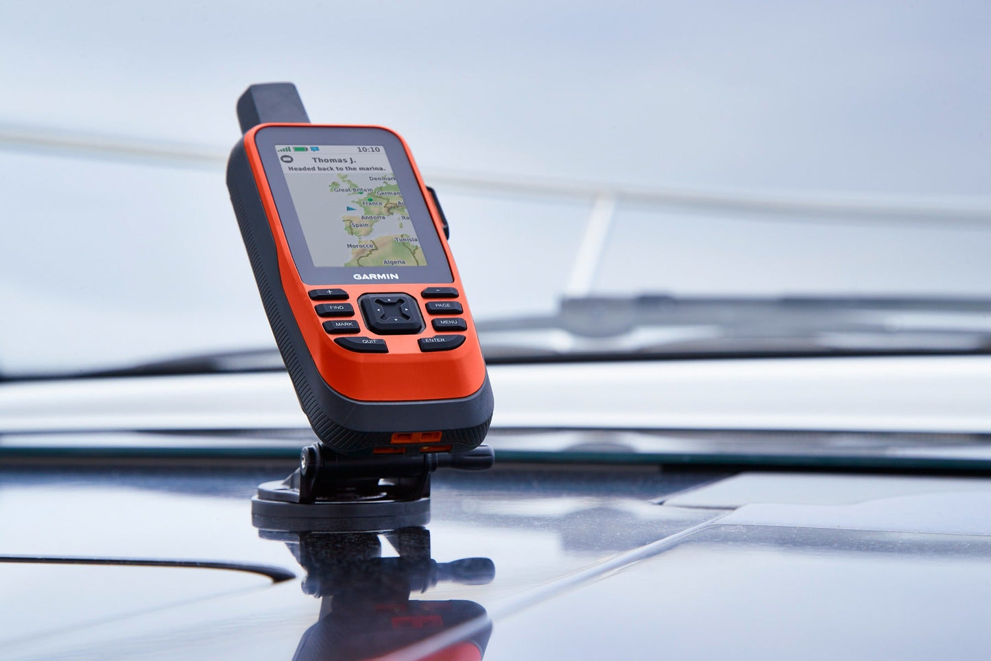 Garmin GPSMAP 86Sci marine handheld GPS navigator, orange/black, mounted on car roof
