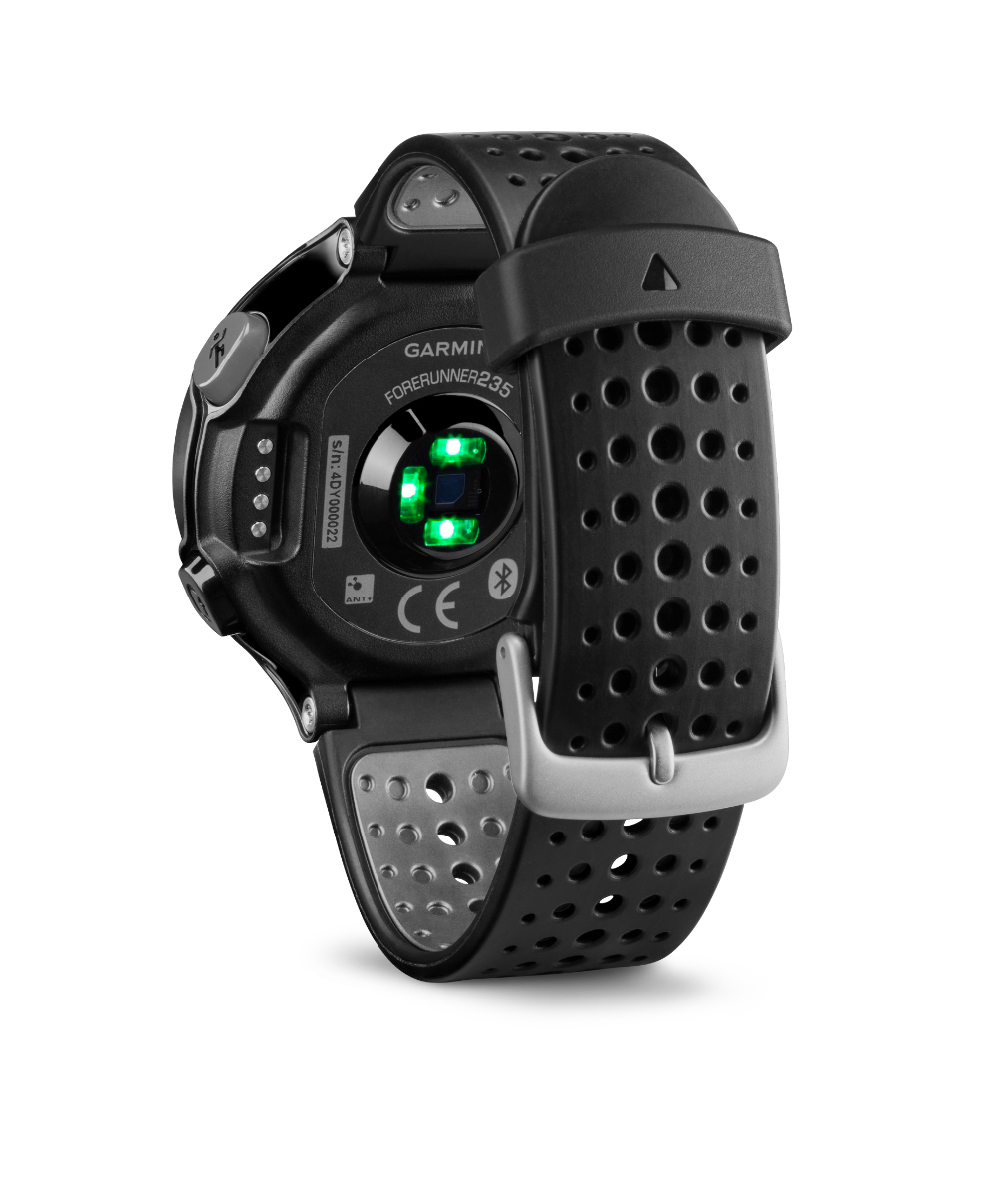 Garmin Forerunner 235 smartwatch with black/gray design and perforated silicone strap, green heart-rate sensors visible.