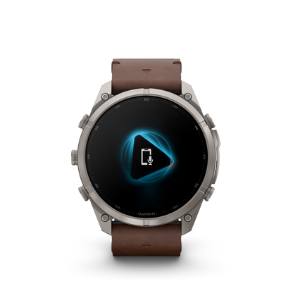 Garmin Fenix 9 Pro smartwatch with walnut leather strap and gray-silver titanium bezel.